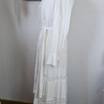 White dress on a mannequin against a neutral background