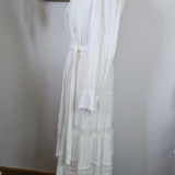 White dress on a mannequin against a neutral background