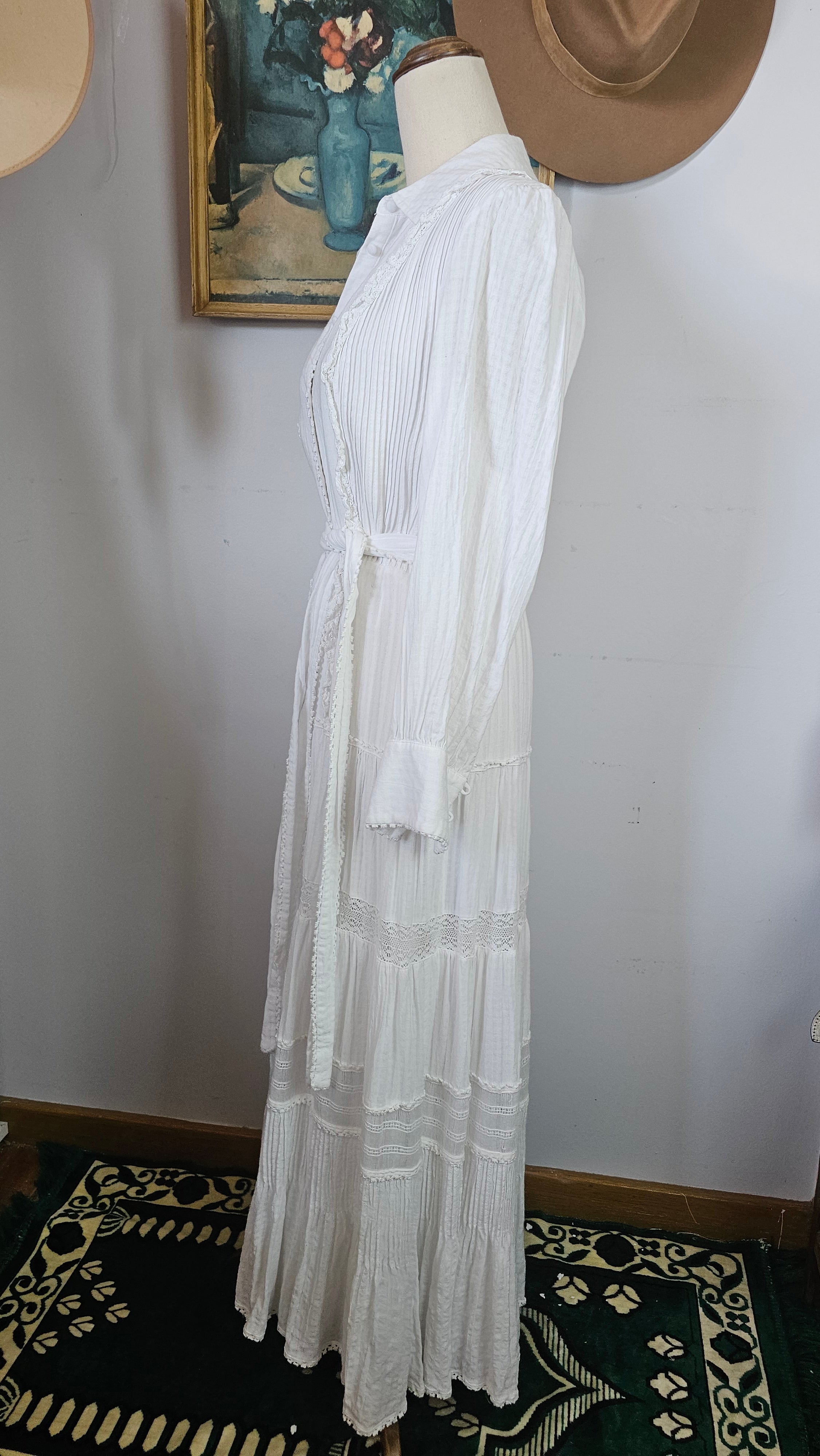 White dress on a mannequin against a neutral background