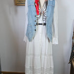 Mannequin wearing a denim jacket with a white shirt and red accents, standing against a plain background.