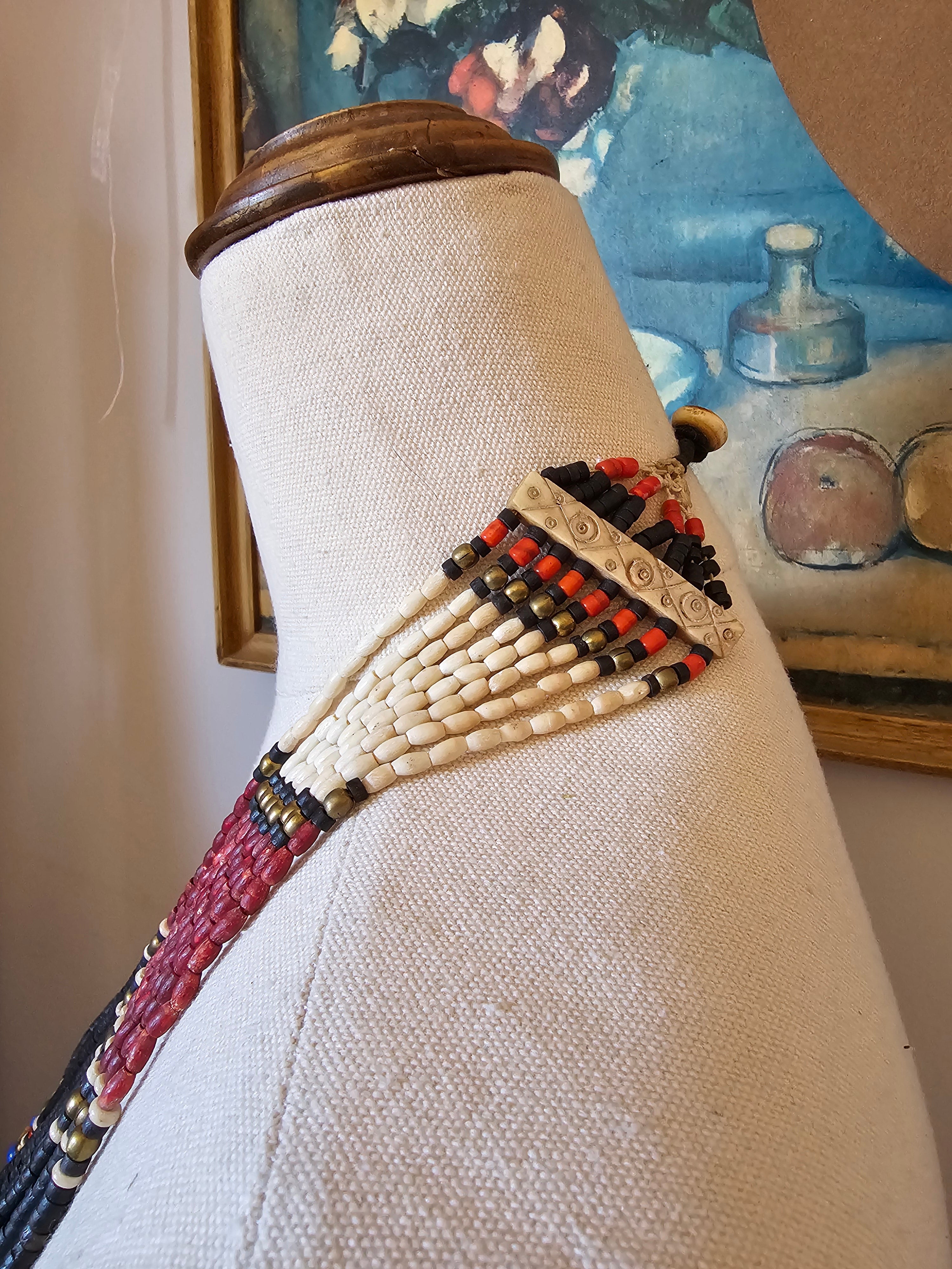 Textile with beadwork on a mannequin against a blurred background
