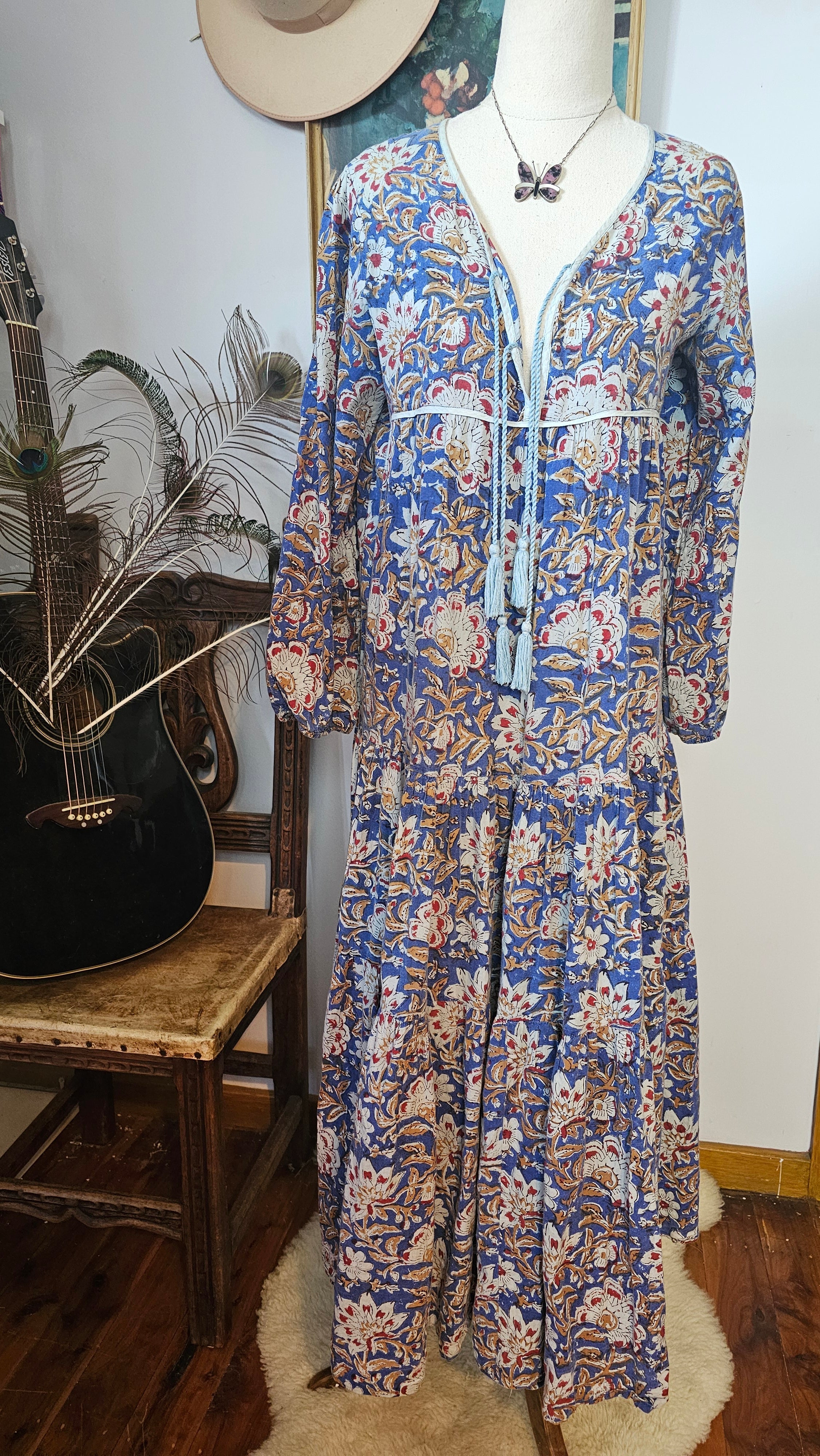 Front view of Property of Zephyr – Sienna Long Layer Dress on mannequin with tassel neckline and floral paisley print, size small.