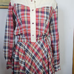 Plaid dress on a mannequin with a plain background