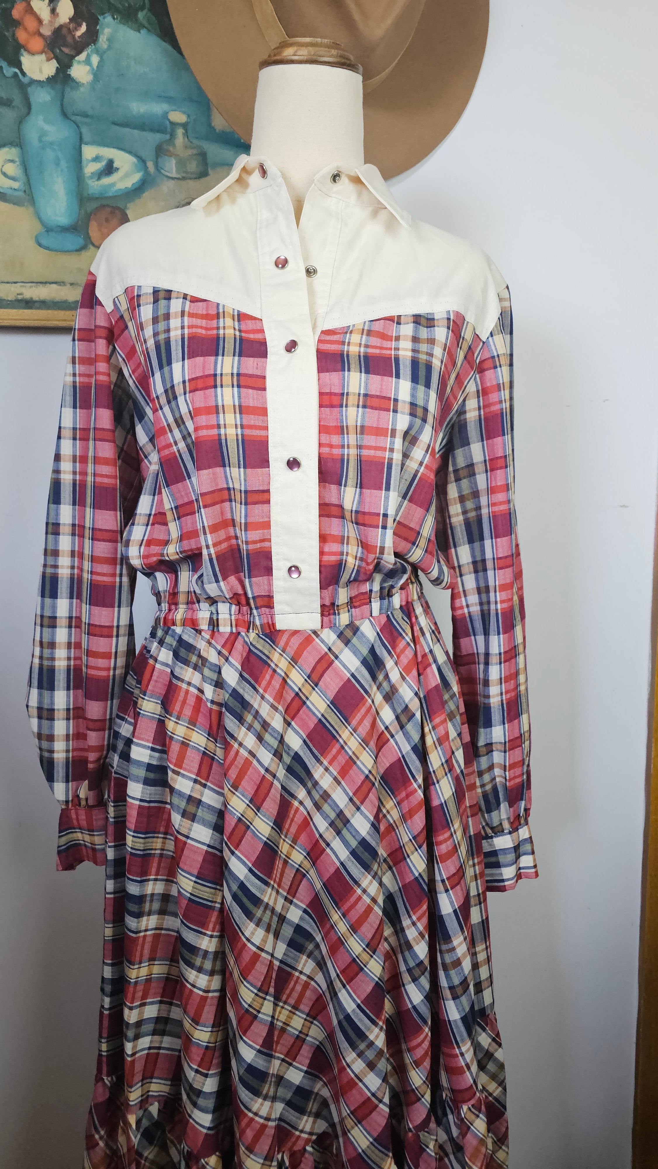Plaid dress on a mannequin with a plain background