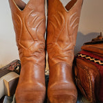 Vintage Brazilian Boots - Size 7B in tan leather with classic Western stitching, displayed front-facing on denim for a rustic 70s boots look.