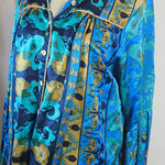 Folded fabric with blue and gold pattern on a white surface