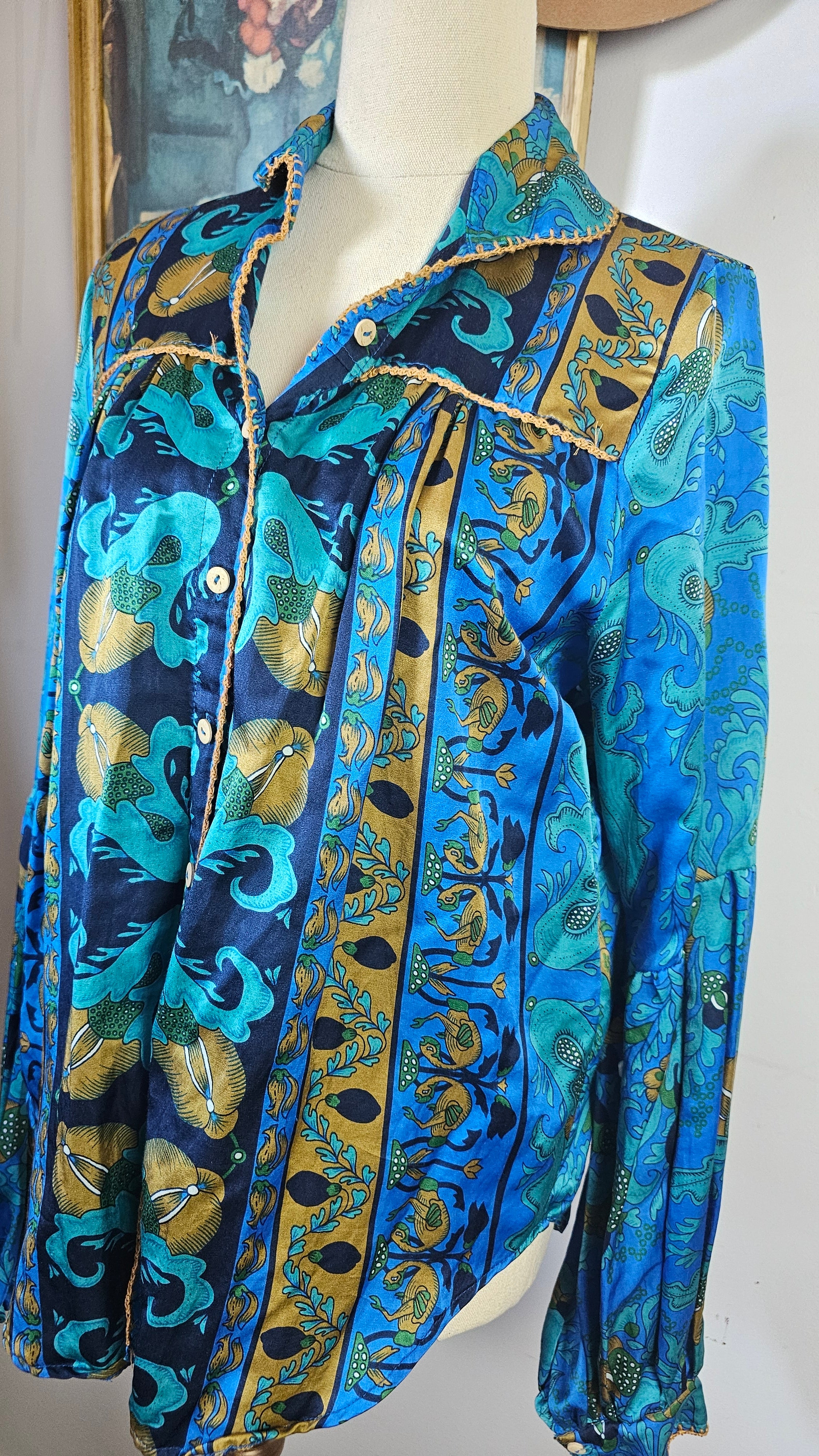Folded fabric with blue and gold pattern on a white surface