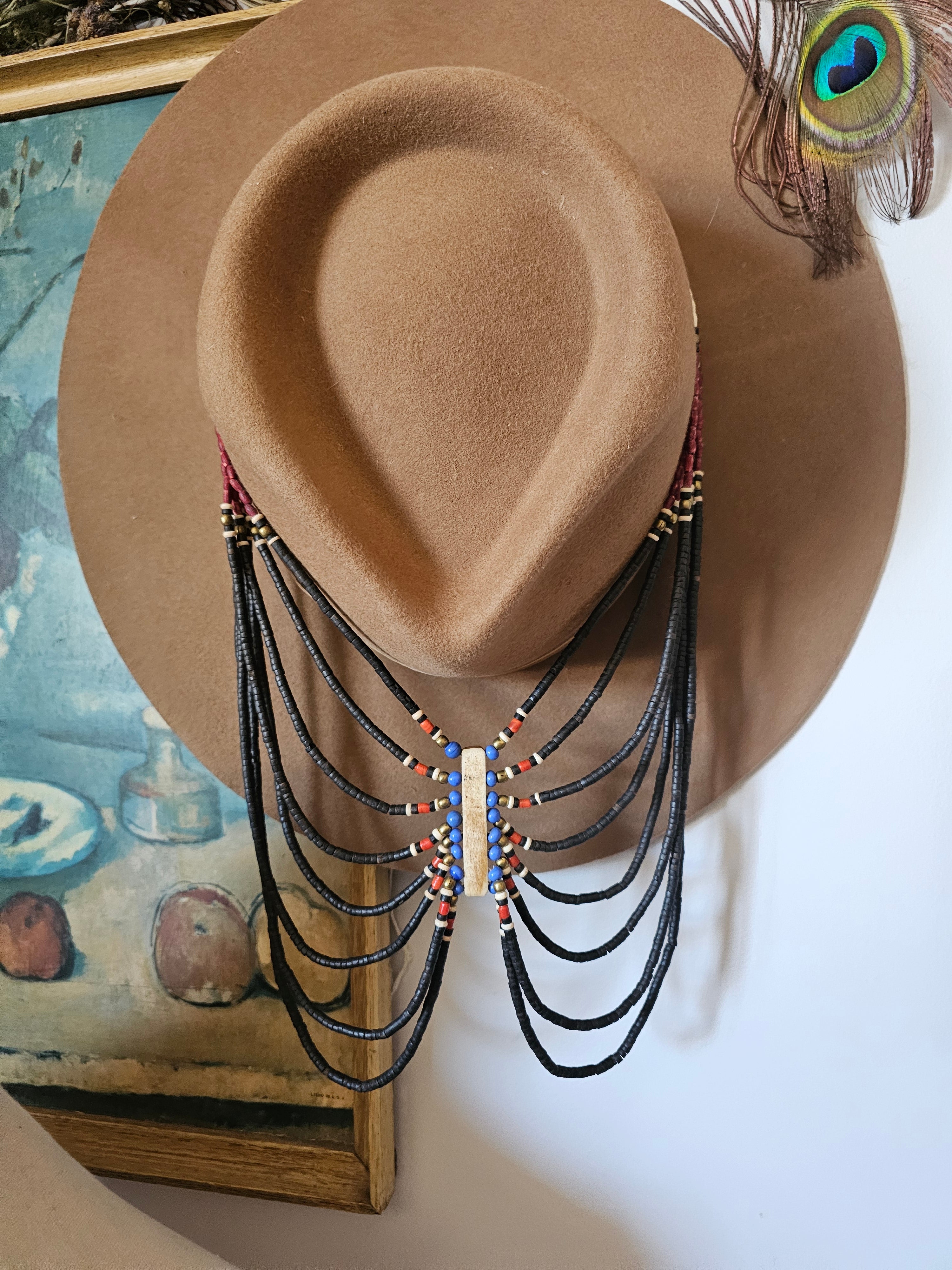 Brown cowboy hat with decorative elements on a white background