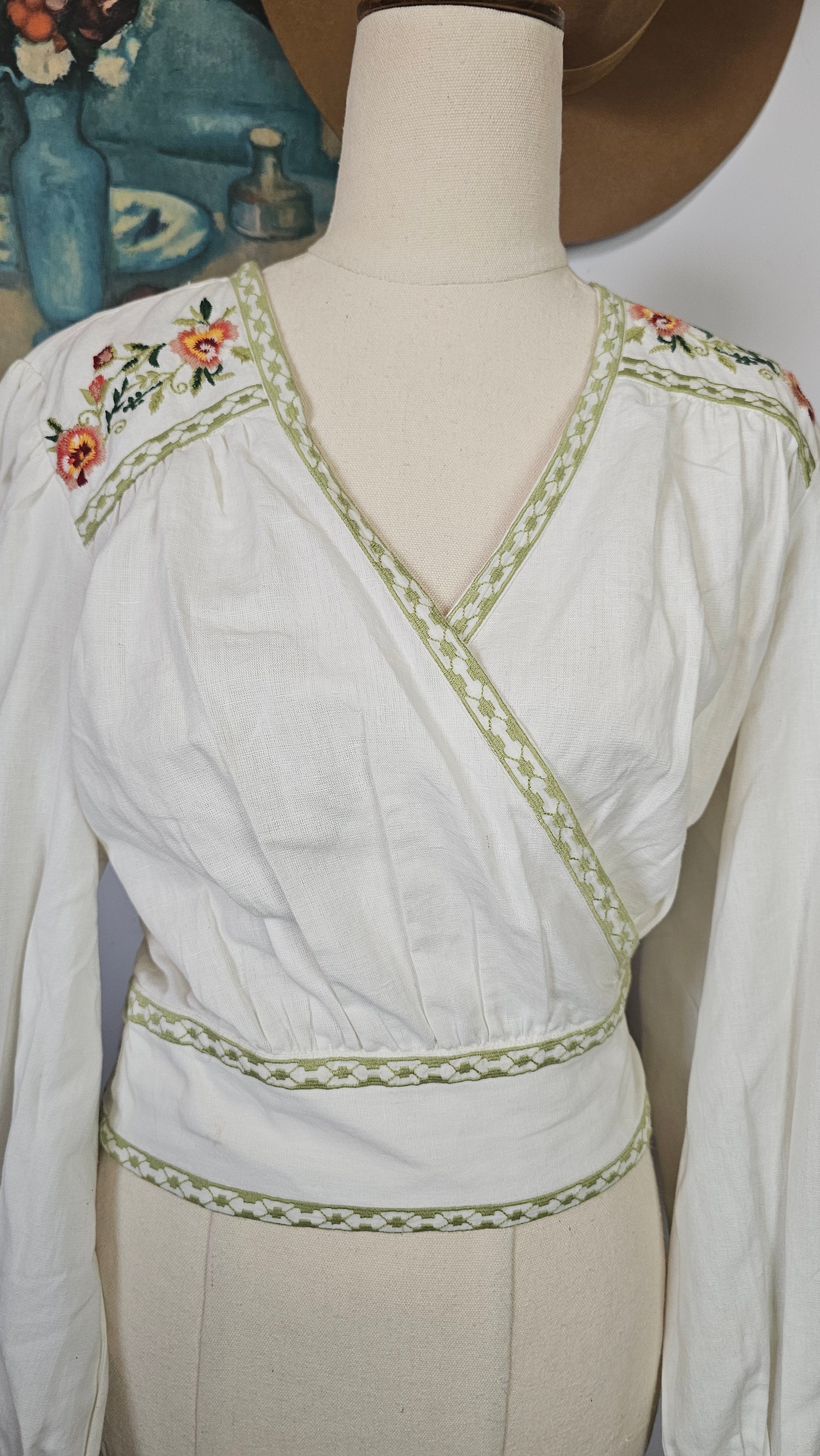 White dress with floral embroidery on a mannequin