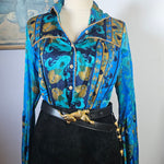 Mannequin wearing a blue patterned jacket with gold accents on a white background
