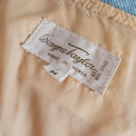 Close-up of a beige fabric with a brand label on a blurred background