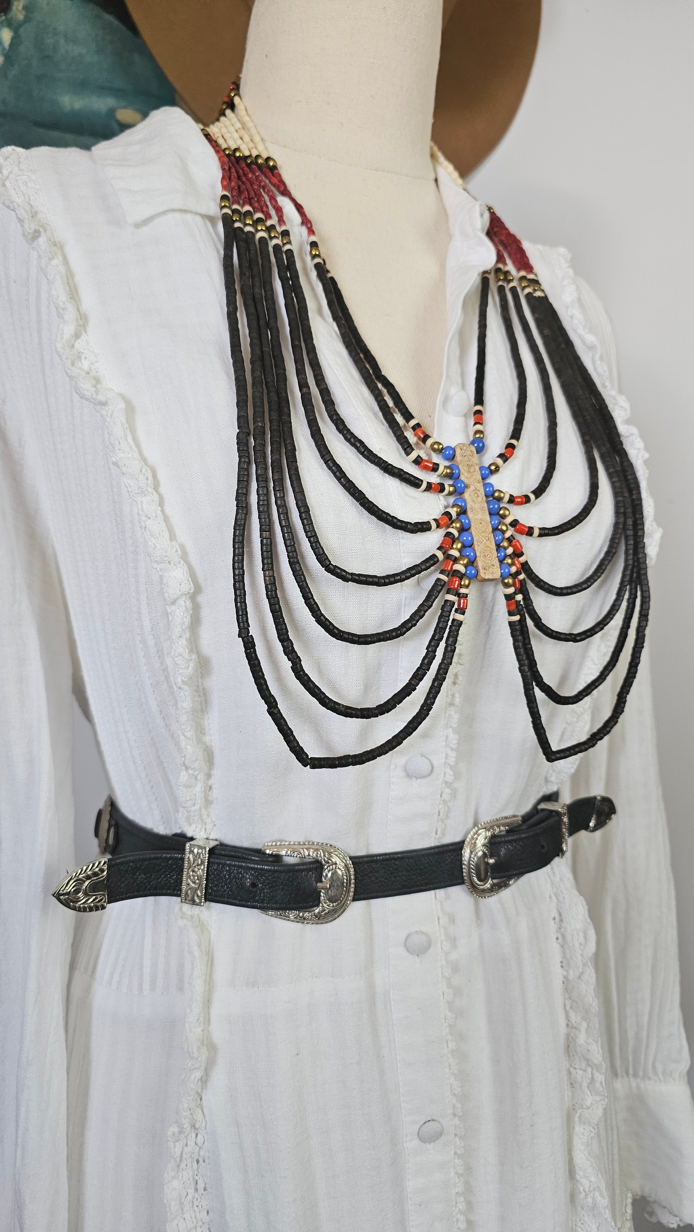 Decorative belt with beads on a white fabric background
