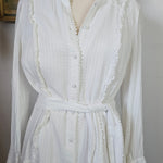 White dress on a mannequin with a plain background
