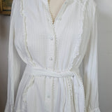 White dress on a mannequin with a plain background