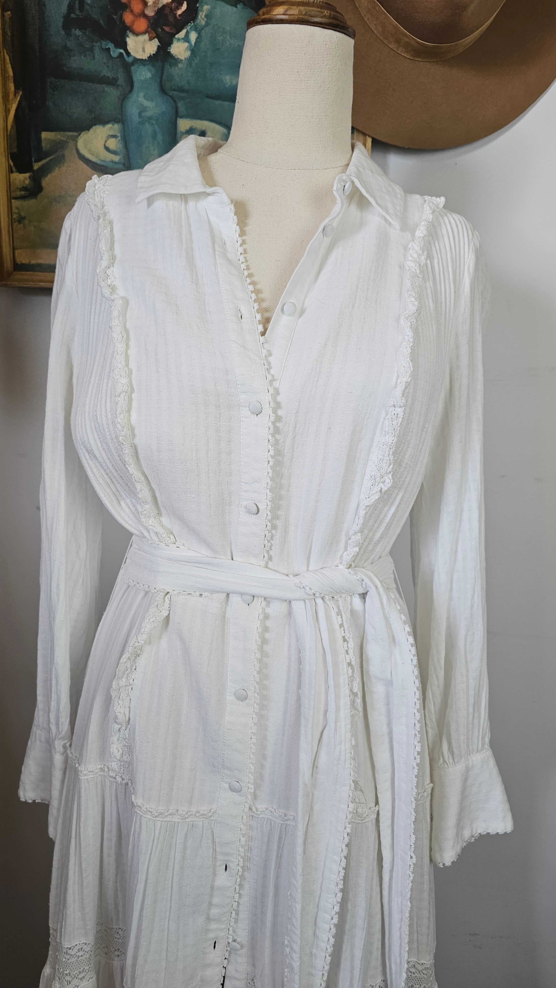White dress on a mannequin with a plain background