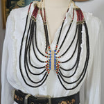 Set of belts displayed on a mannequin with a white background