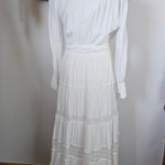 White dress on a mannequin with a plain background