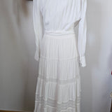 White dress on a mannequin with a plain background