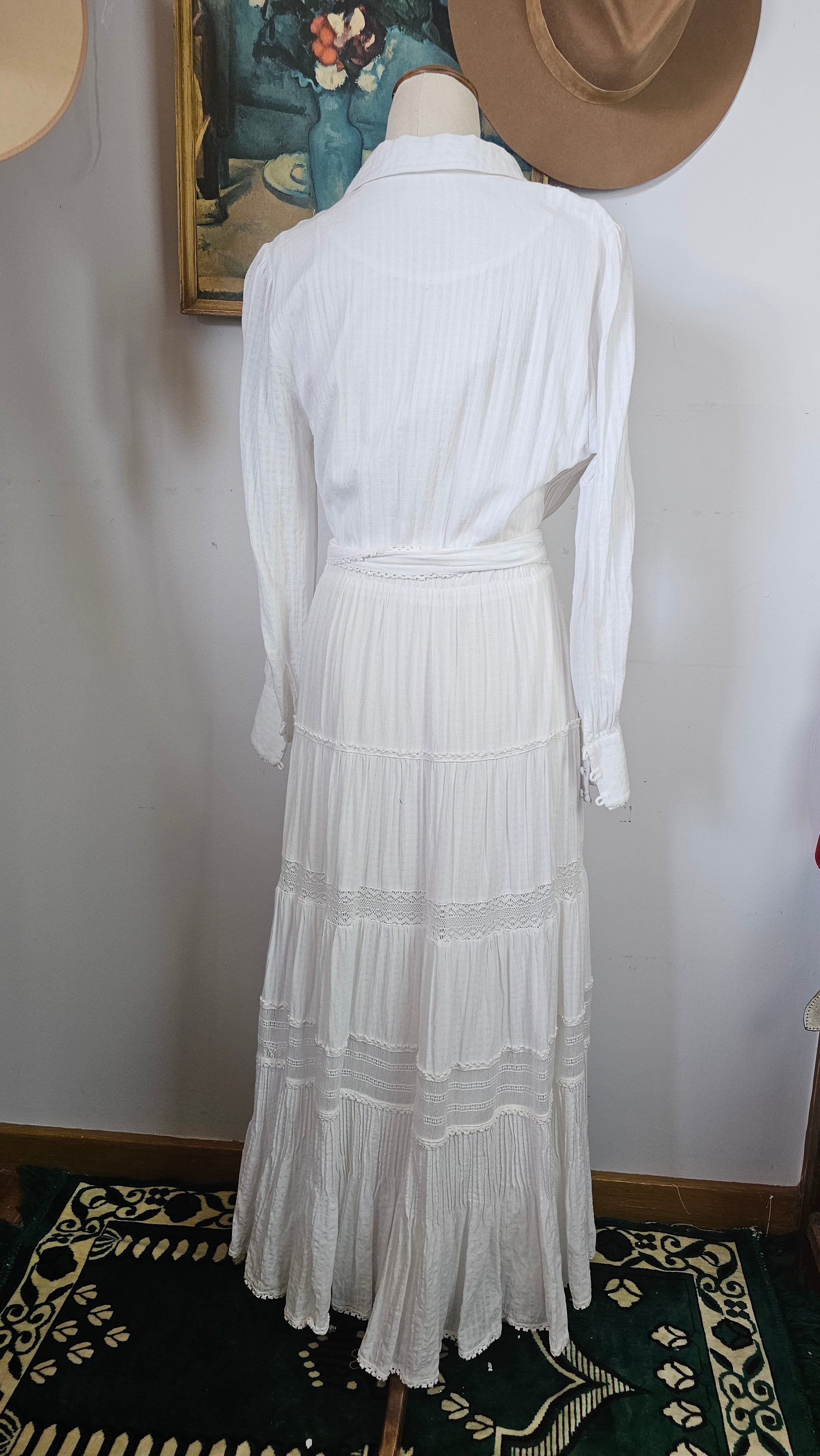 White dress on a mannequin with a plain background