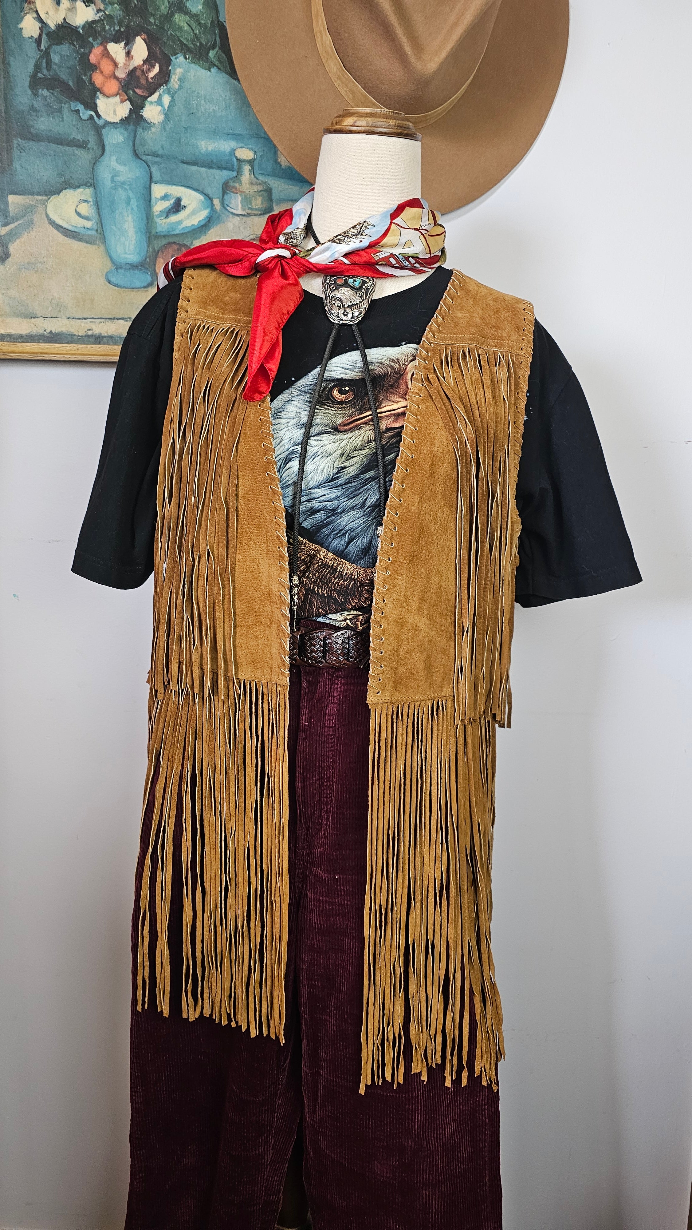 Traditional outfit with fringed jacket and hat on a white background