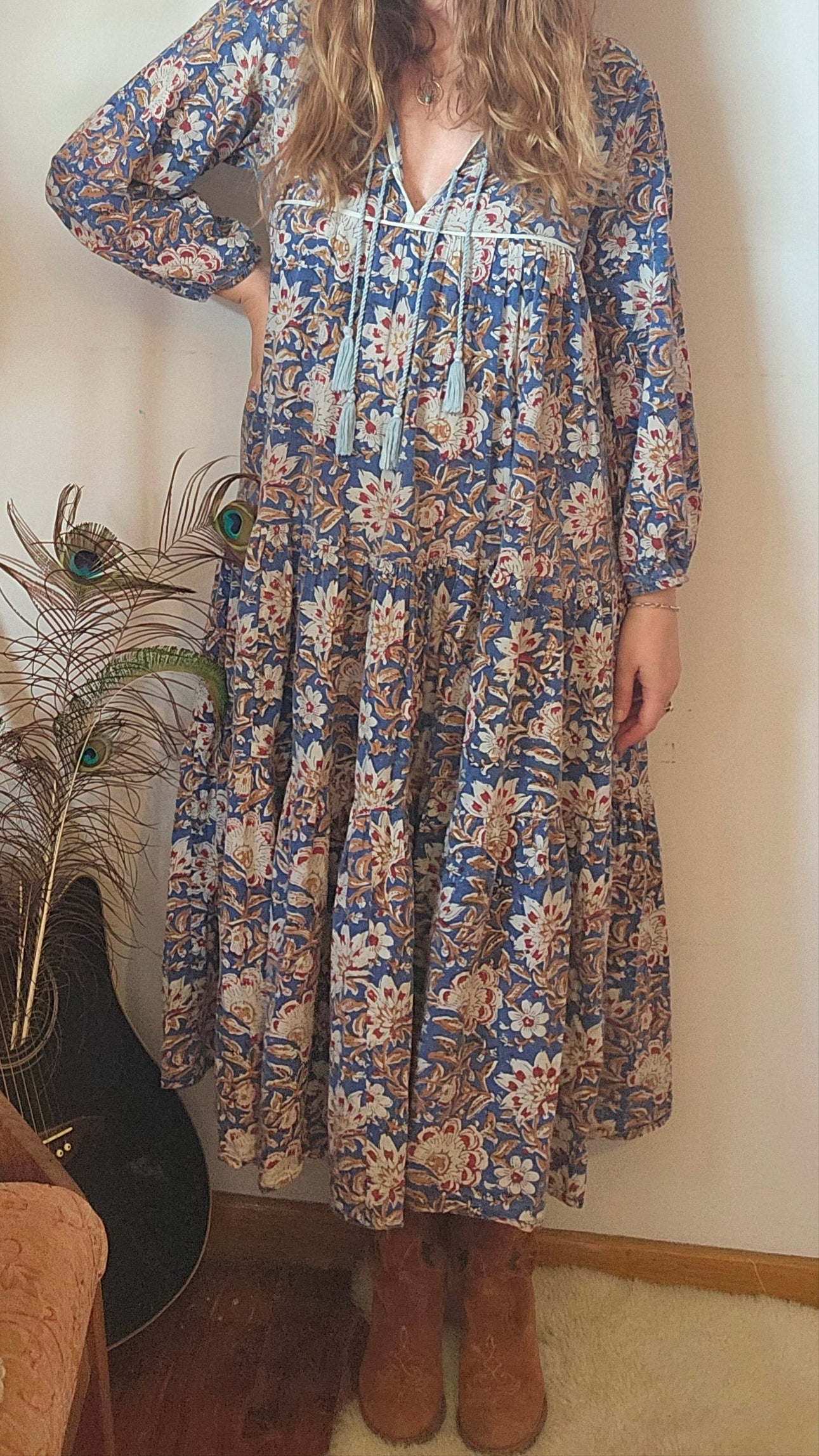Front view of model in Property of Zephyr – Sienna Long Layer Dress with long sleeves and tiered skirt in blue and cream floral, size small.