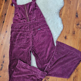 Purple corduroy pants on a wooden floor with a white rug underneath