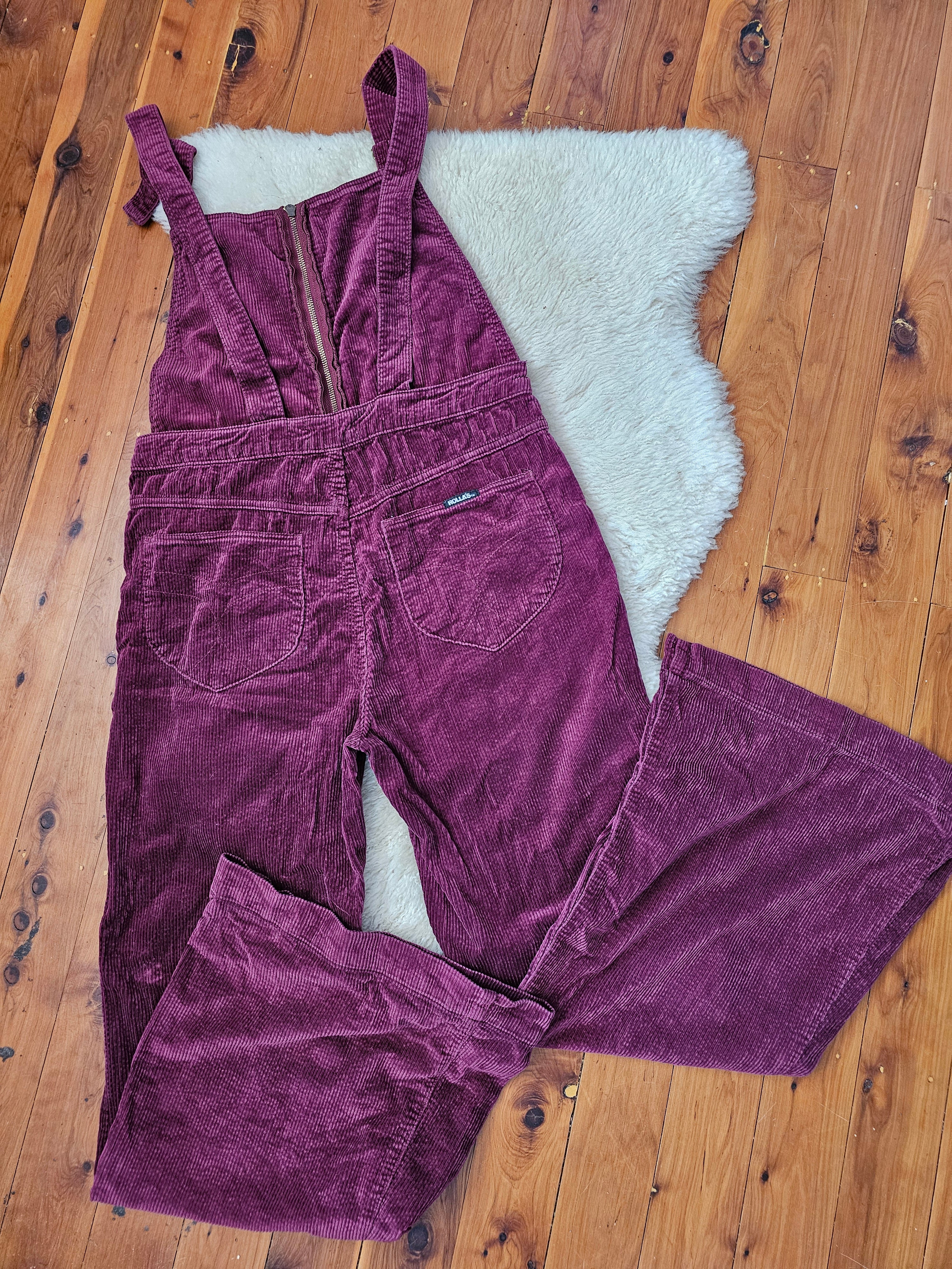 Purple corduroy pants on a wooden floor with a white rug underneath
