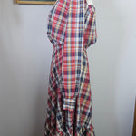 Plaid fabric on a mannequin against a plain background