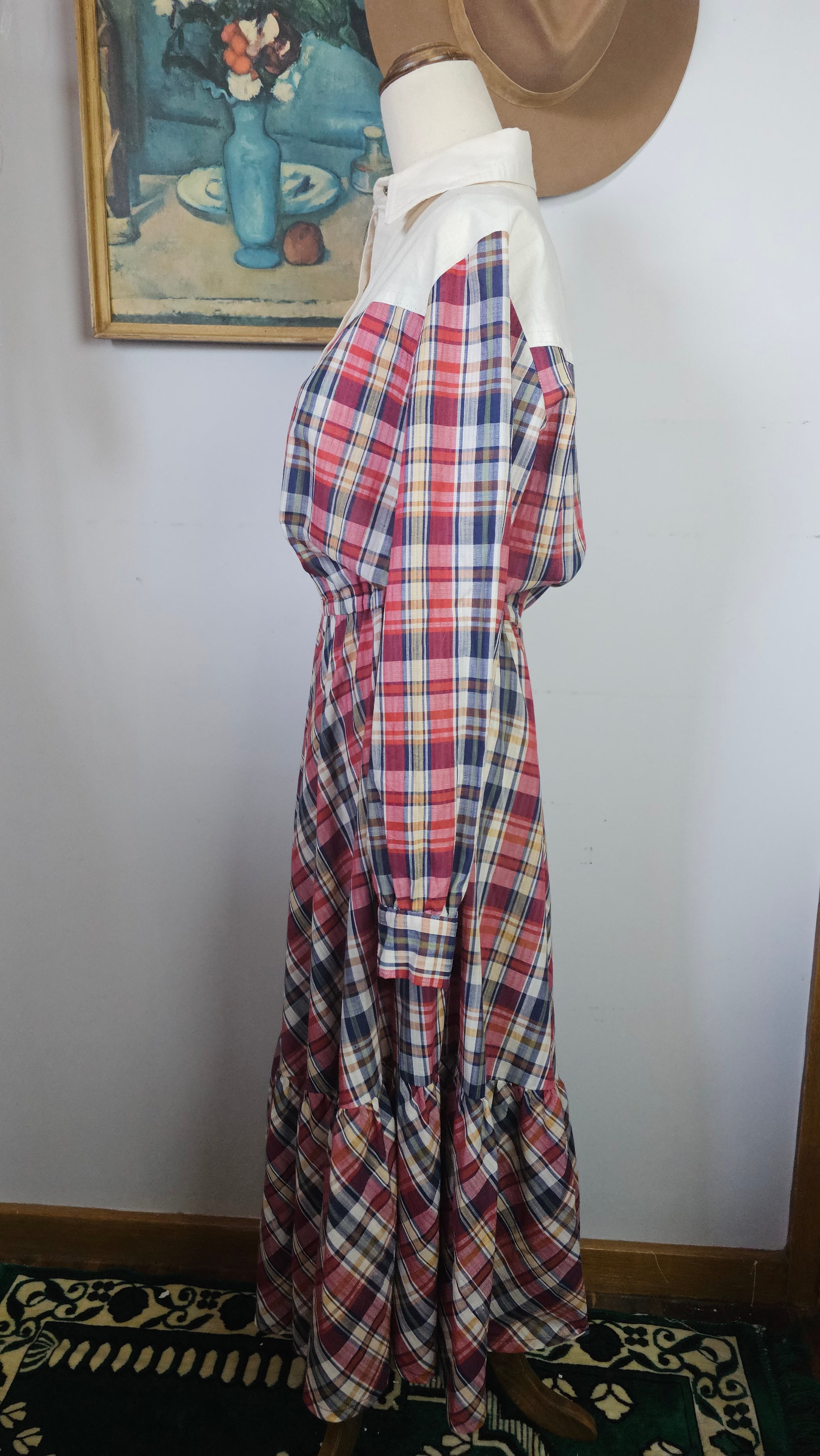 Plaid fabric on a mannequin against a plain background
