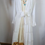 White fabric on a mannequin with decorative elements in the background
