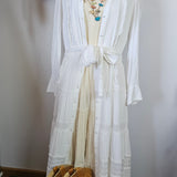 White fabric on a mannequin with decorative elements in the background