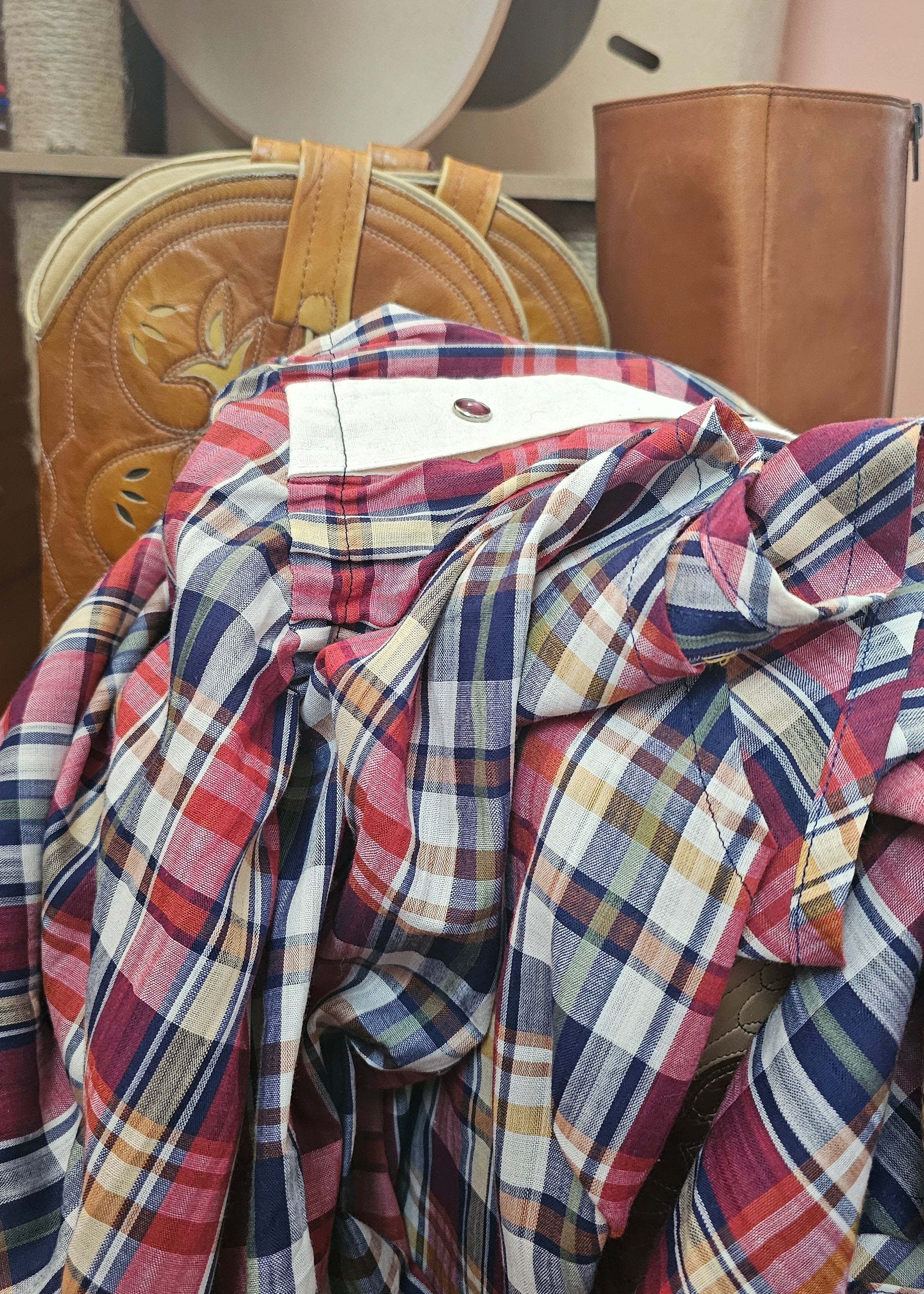 Plaid shirt on a wooden surface with a blurred background