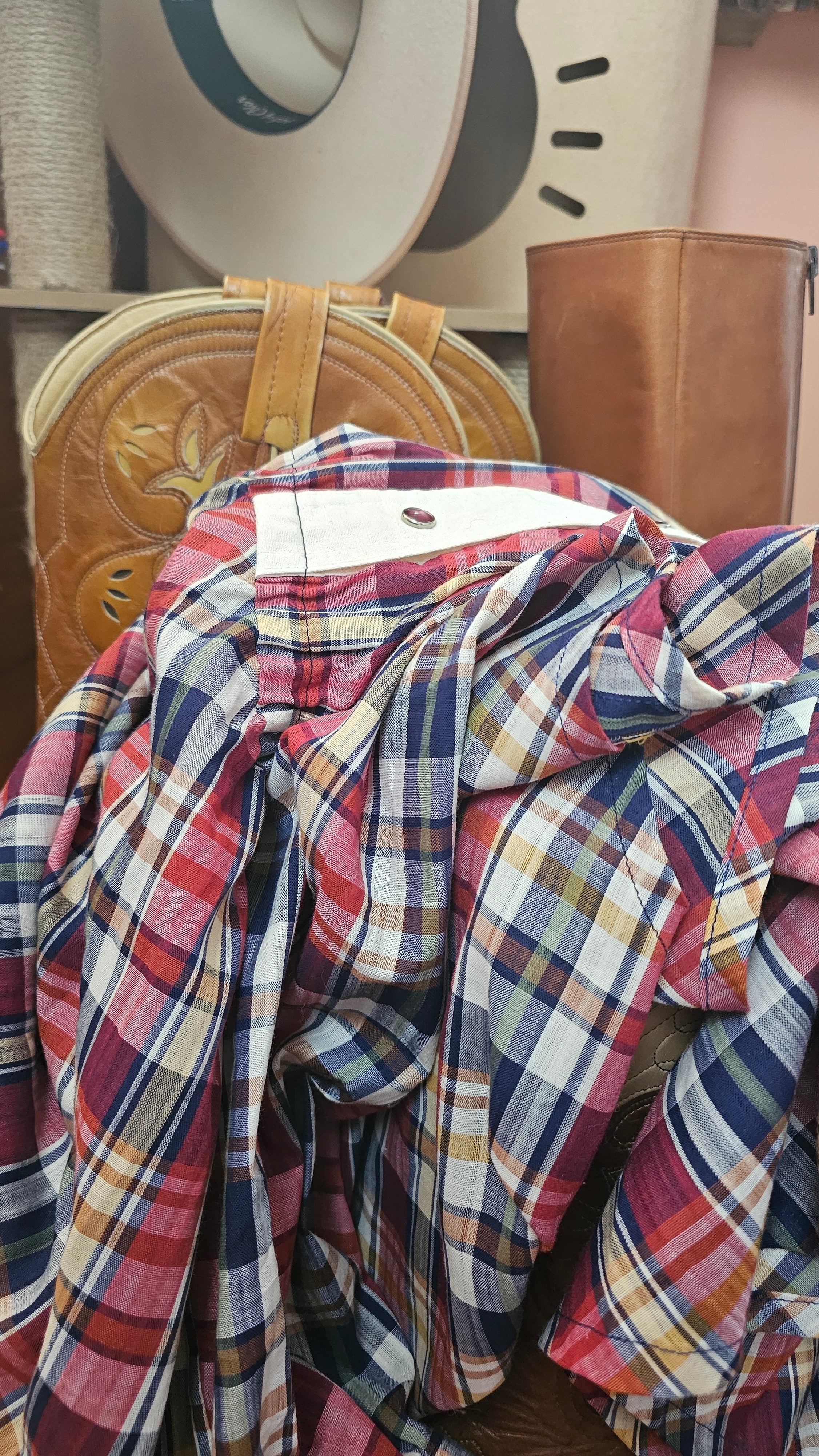 Plaid shirt on a wooden surface with a blurred background