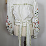 White dress with floral embroidery on a white background