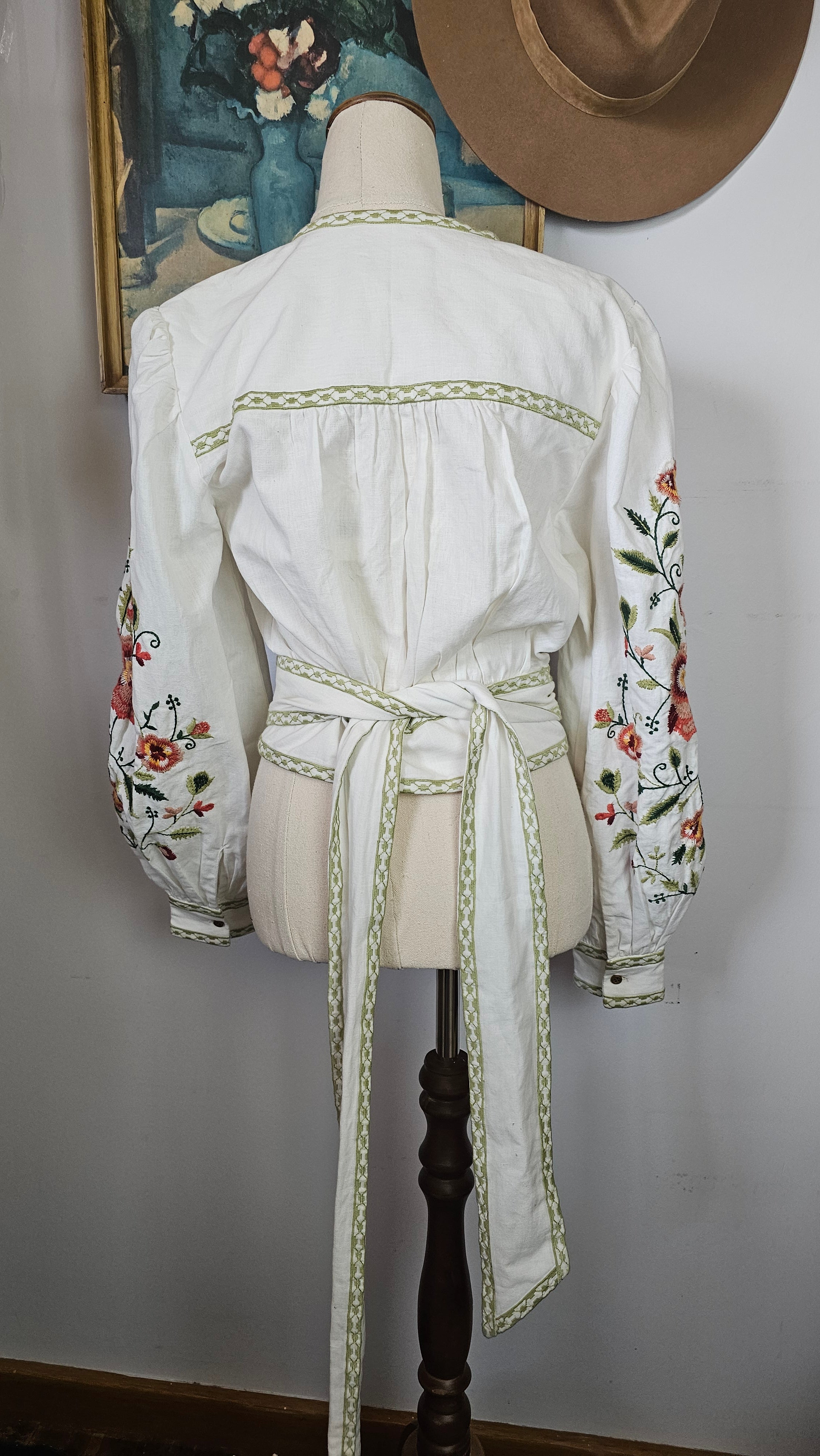White dress with floral embroidery on a white background