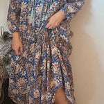 Close-up of Property of Zephyr – Sienna Long Layer Dress showing tassel tie neckline and soft cotton fabric in floral paisley, size small.