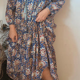 Close-up of Property of Zephyr – Sienna Long Layer Dress showing tassel tie neckline and soft cotton fabric in floral paisley, size small.