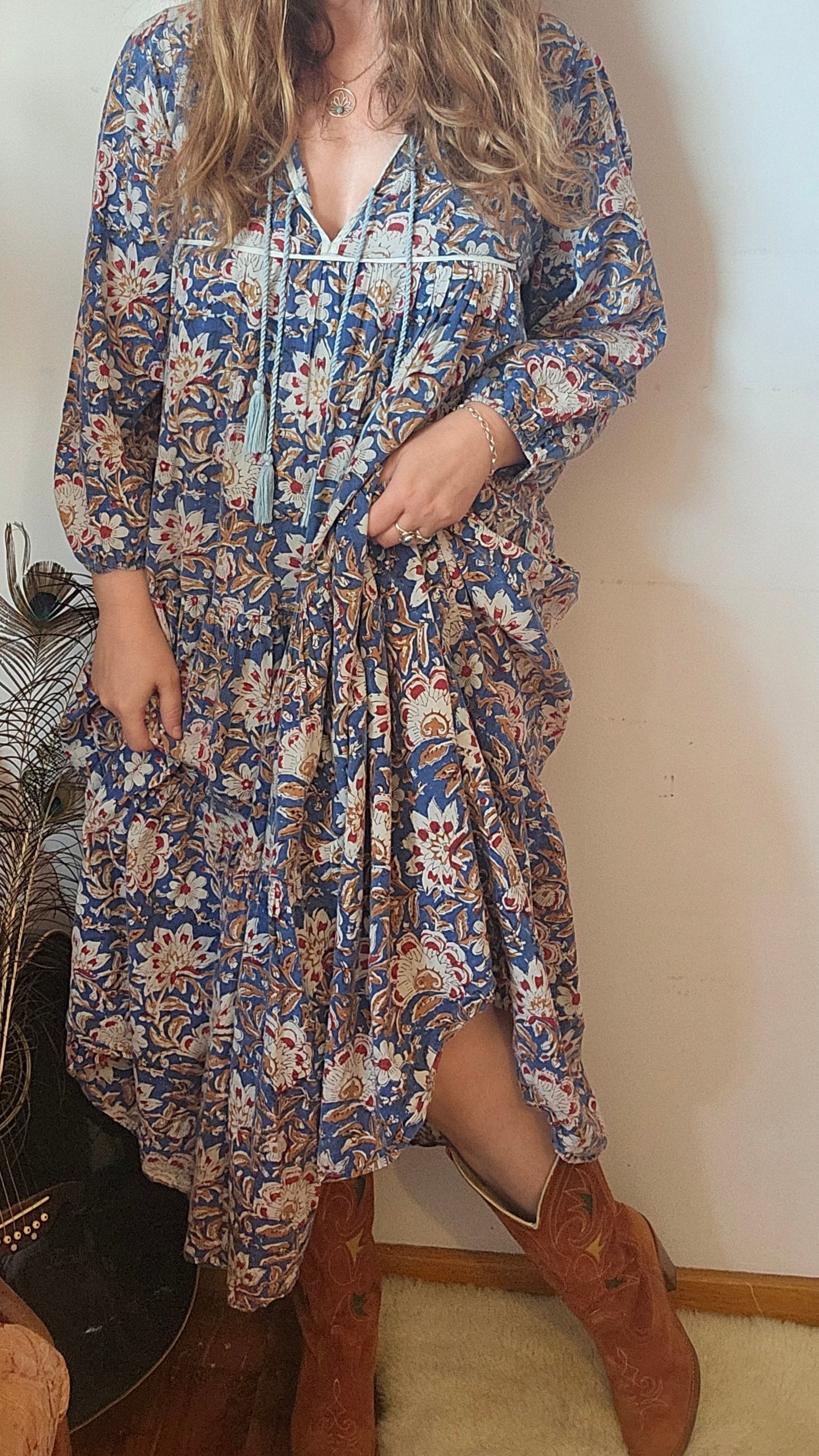 Close-up of Property of Zephyr – Sienna Long Layer Dress showing tassel tie neckline and soft cotton fabric in floral paisley, size small.