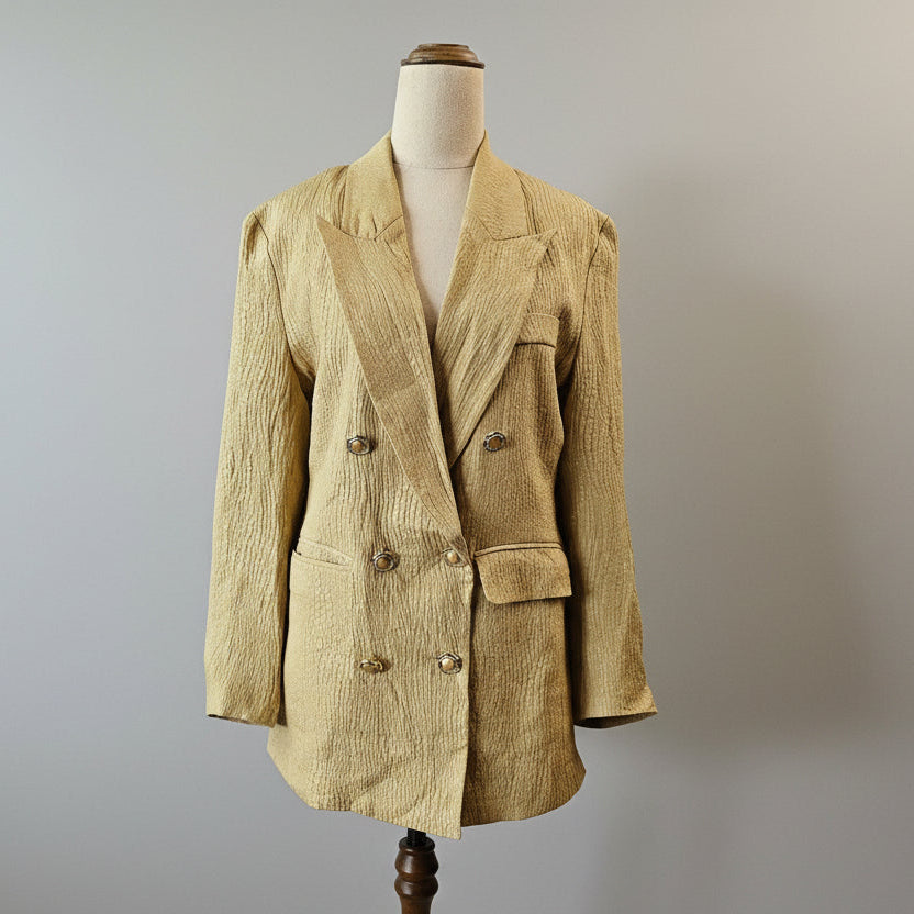 Beige blazer on a mannequin against a plain background