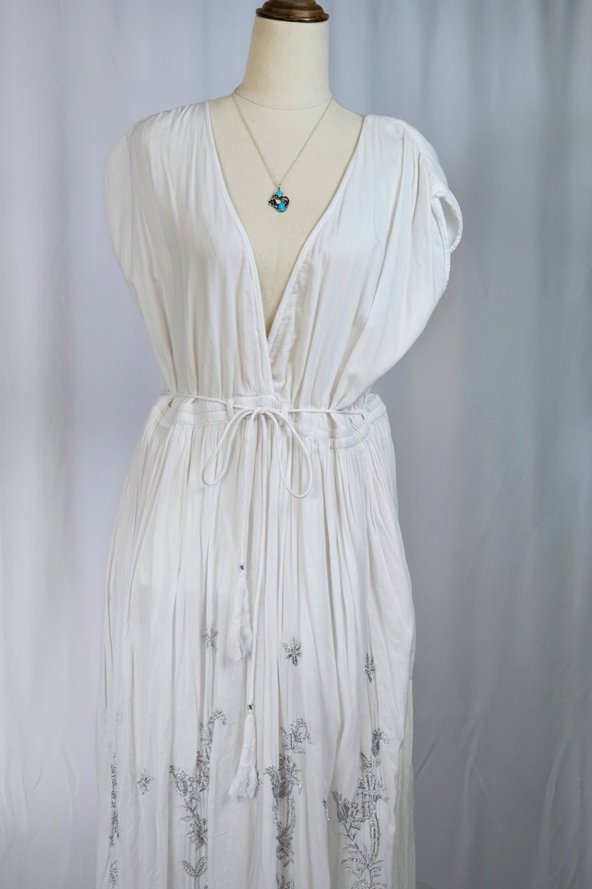 White dress on a mannequin against a plain background