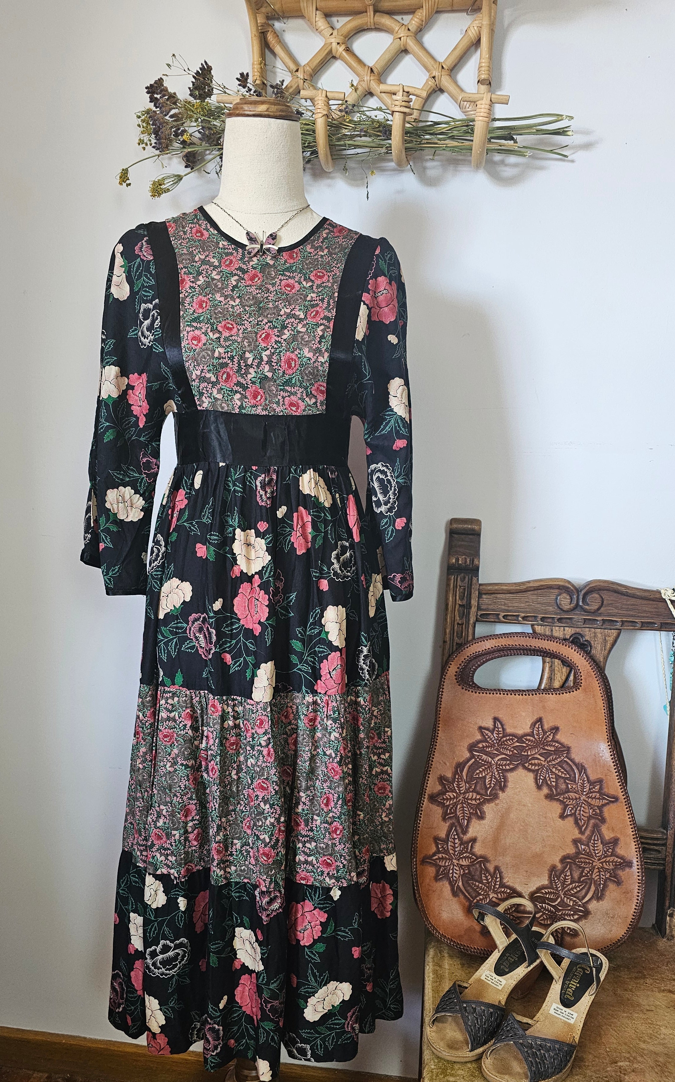Vintage Chameleon Sydney floral dress on a mannequin, featuring a round neckline, 3/4 sleeves, and a flowy midi length with a twirl-worthy skirt, displayed in a bohemian setting.