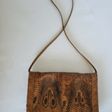 Brown textured handbag on a white background