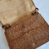 Brown leather-bound book with visible wear on a white background