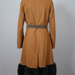 Brown leather jacket with black fur trim on a mannequin against a white background