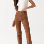 Full front view of Rolla’s Dusters Bootcut cords in Tobacco, size 30, paired with a white top and white boots for a vintage-inspired look.
