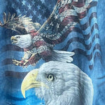 A blue acid-wash graphic t-shirt featuring a bald eagle and an American flag design, with 'JACKSONAWAY' printed on the inner neck label.
