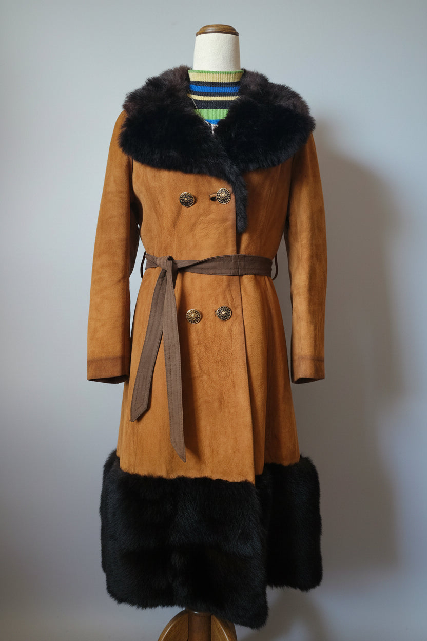 Brown coat with black fur trim on a mannequin against a white wall.