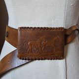 Brown leather belt with embossed design on a light gray background