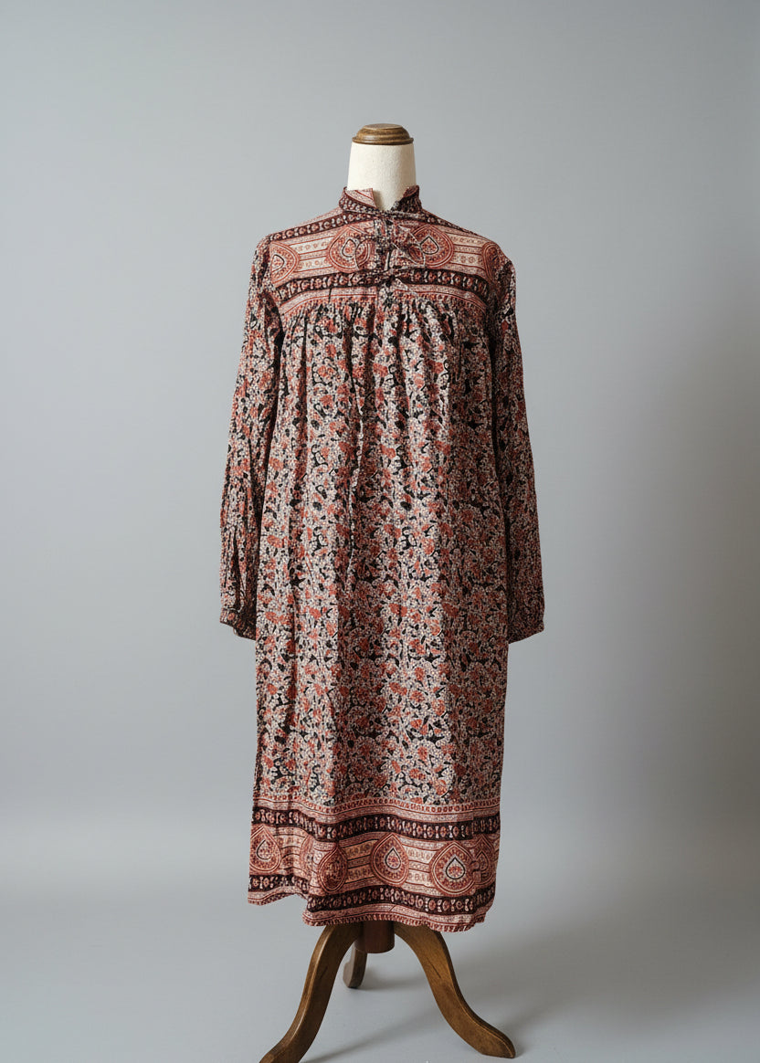 Long patterned dress on a mannequin against a gray background