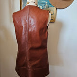 Brown leather bag on a mannequin against a neutral background